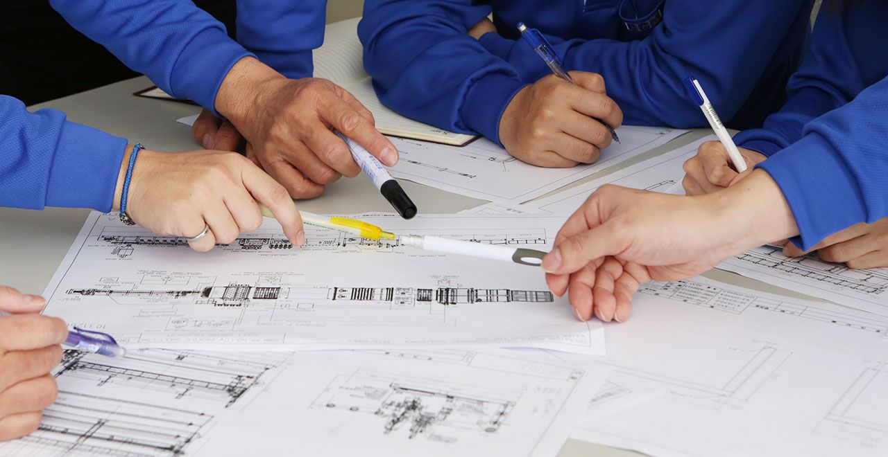Engineers reviewing blueprints together.