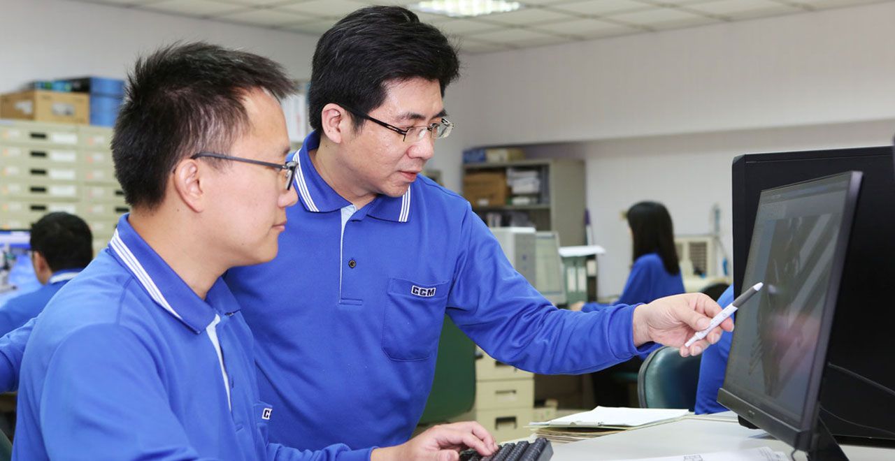 Engineers collaborating at a computer screen